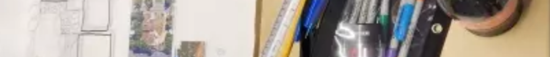 drawings and art supplies on a table