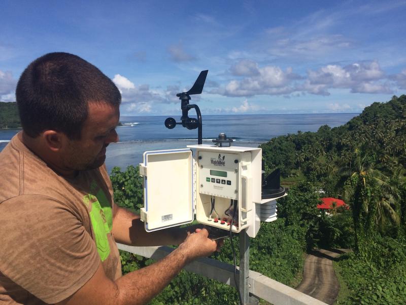 Man looking at a weather instrument panel