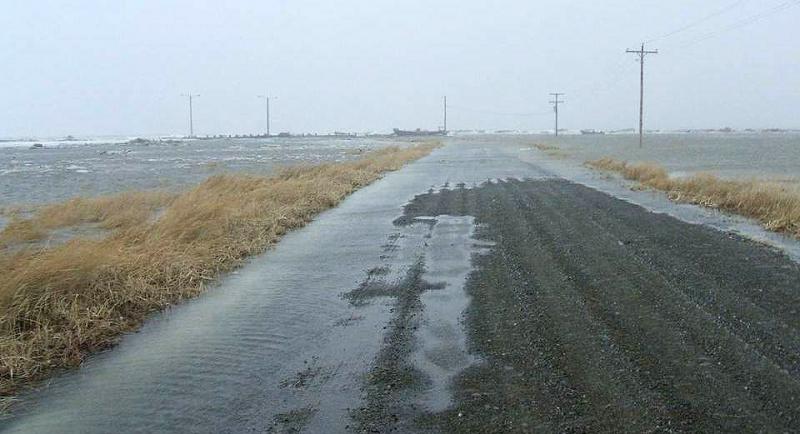 Ocean water inundating gravel roadway