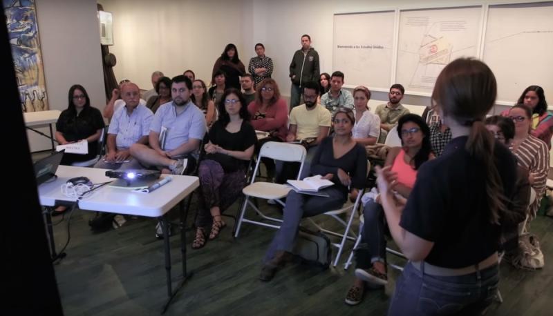 People in a workshop watching a slide presentation