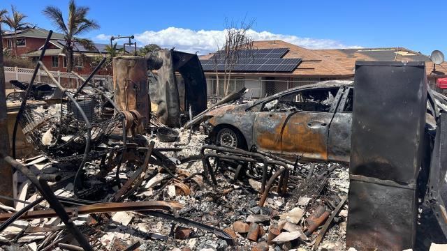 A home and car scorched by a devastating wildfire.