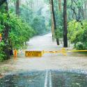 Flooded road and caution sign